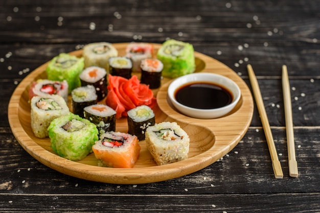 Fresh and tasty sushi on dark background. It can be used as a background