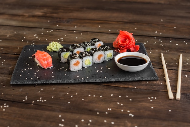 Fresh and tasty sushi on dark background.