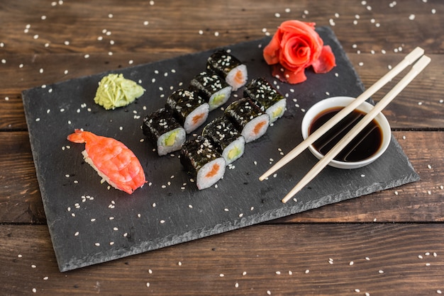 Fresh and tasty sushi on dark background.