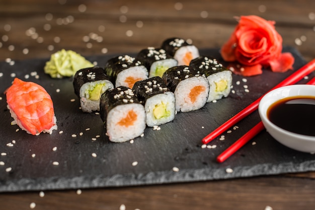 Fresh and tasty sushi on dark background.