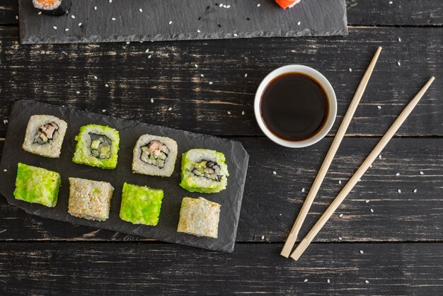 Fresh and tasty sushi on dark background.