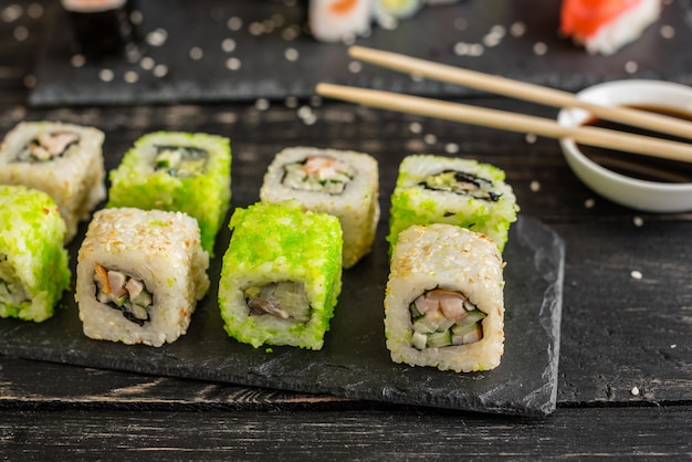 Fresh and tasty sushi on dark background. 