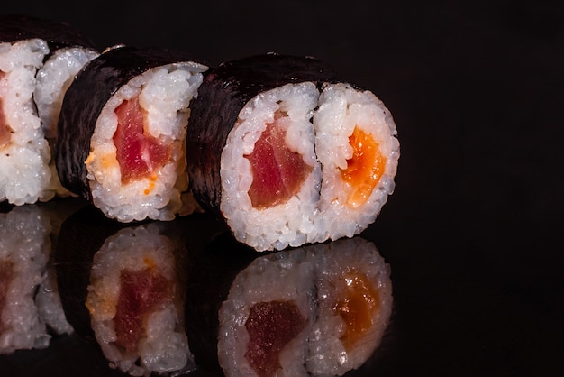 Fresh and tasty sushi on dark background