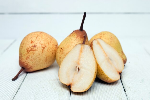 Fresh tasty yellow pear fruits isolated on a white background.