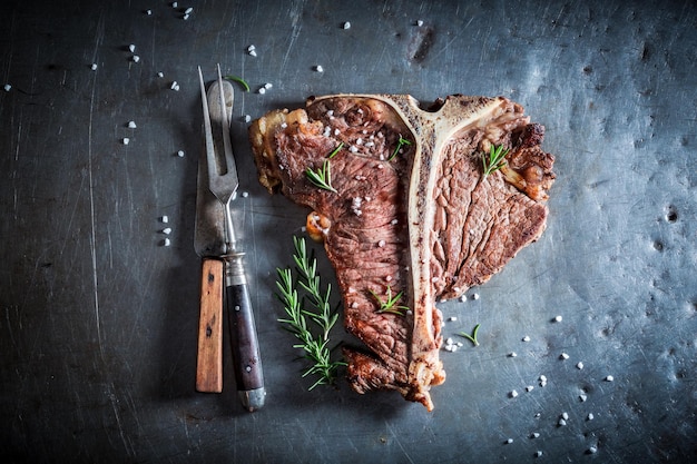 Fresh tbone steak and chips with salt and rosemary