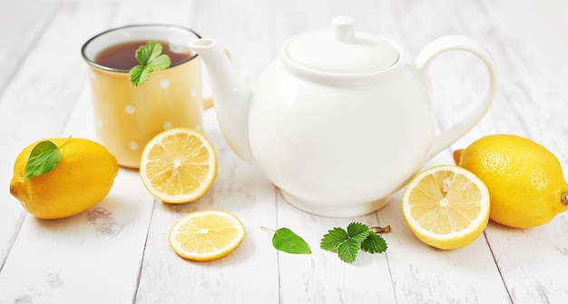 Fresh tea with lemon on wooden table