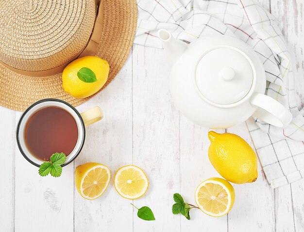 Fresh tea with lemon on wooden table