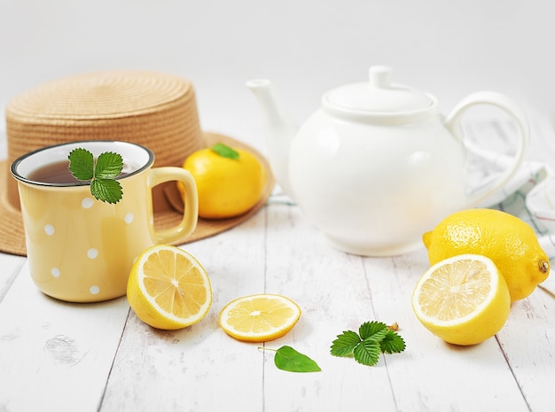 Fresh tea with lemon on wooden table