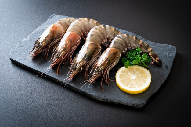 fresh tiger prawn or shrimp on black board