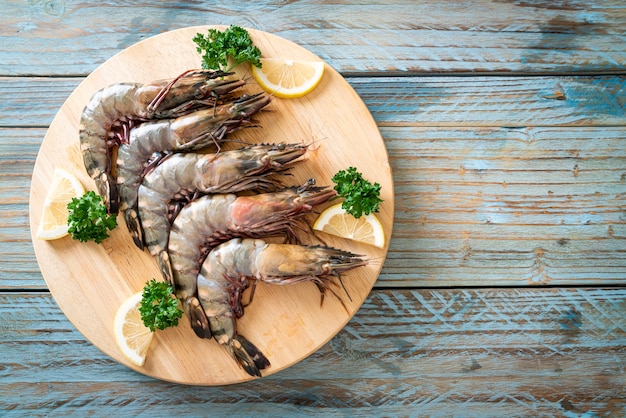 fresh tiger prawn or shrimp on wood board