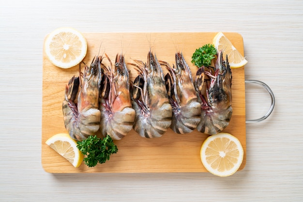 fresh tiger prawn or shrimp on wood board