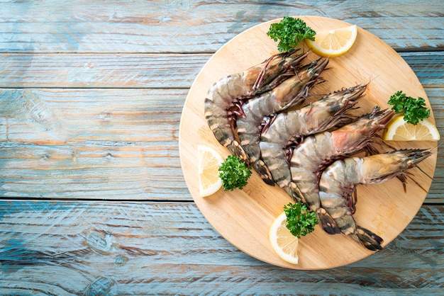 fresh tiger prawn or shrimp on wood board