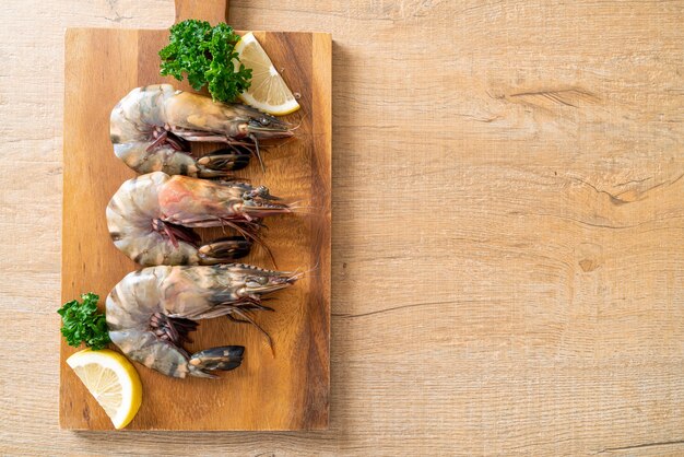 fresh tiger prawn or shrimp on wood board