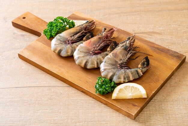 fresh tiger prawn or shrimp on wood board