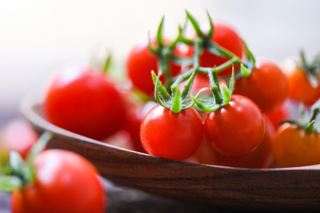 Fresh tomato cherry organic / Close up ripe red tomatoes wooden spoon