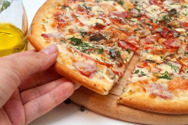 Fresh tomato mushroom cheese and sausage pizza on a round board isolated on white background