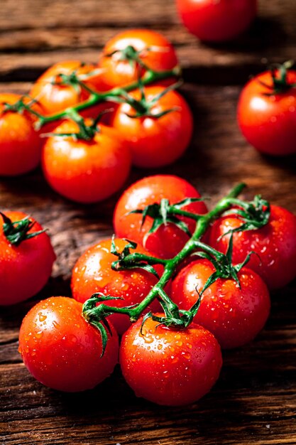 Fresh tomatoes on a branch on the table