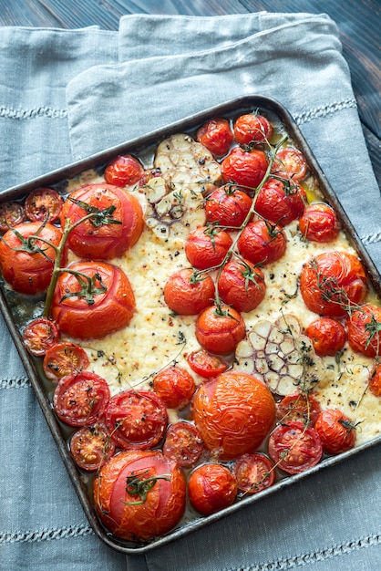 Fresh tomatoes, feta, garlic and thyme on the tray