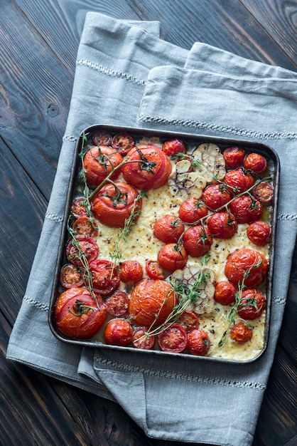 Fresh tomatoes, feta, garlic and thyme on the tray