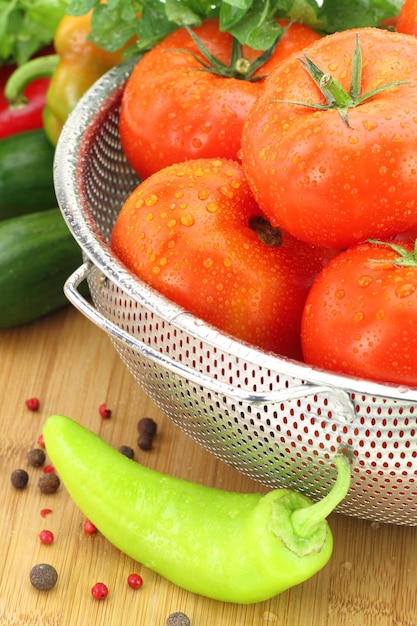 Fresh tomatoes in metal colander