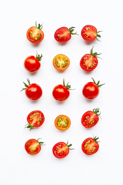 Fresh tomatoes, whole and half cut isolated on white.