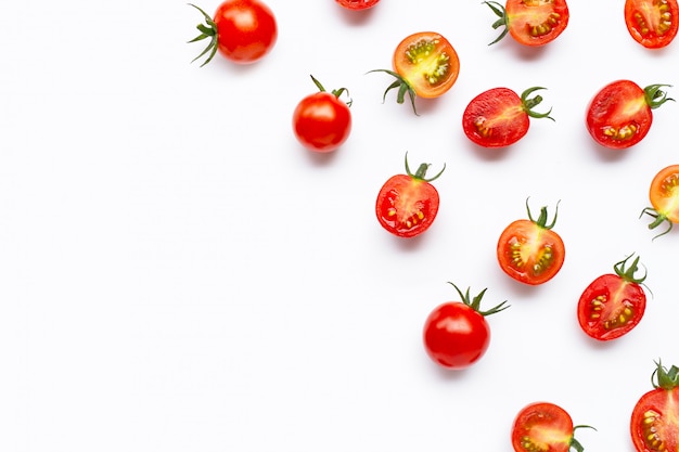 Fresh tomatoes, whole and half cut isolated on white .