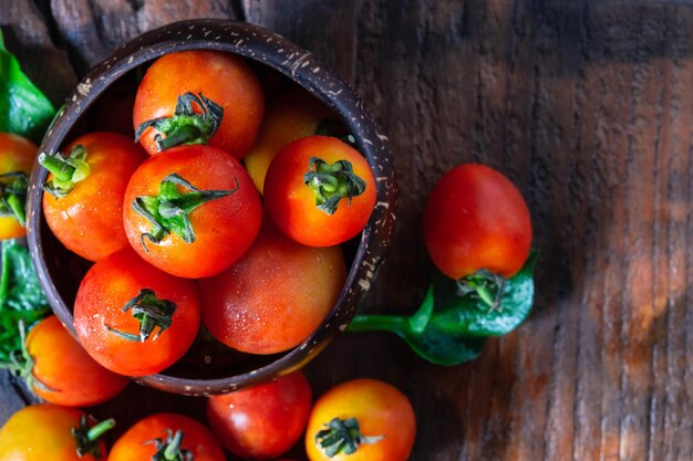 Fresh tomatoes on wooden background