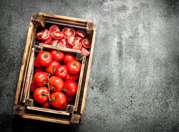 Fresh tomatoes in a wooden box