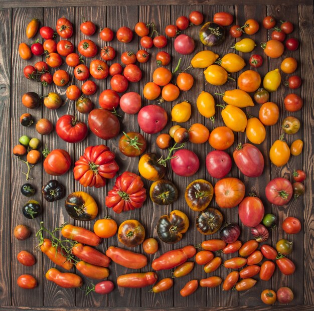 Fresh tomatoes on wooden table close up