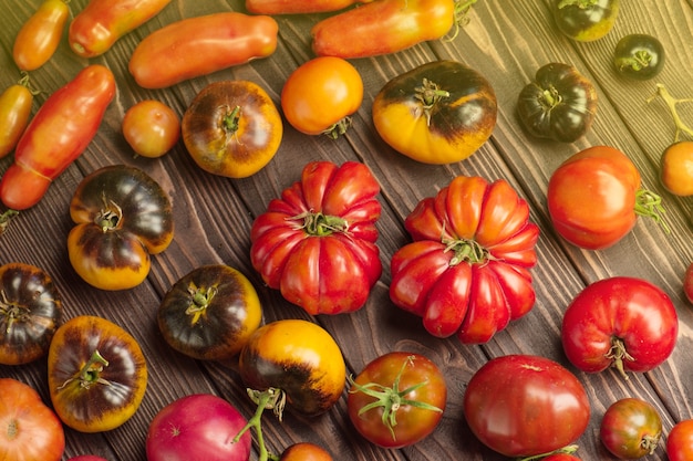 Fresh tomatoes on wooden table close up