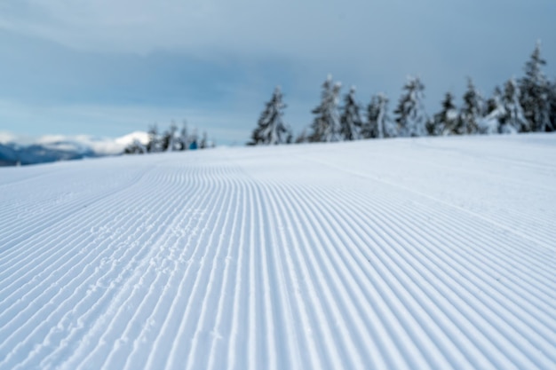 Fresh tracks of snowcat at the ski resort slopes
