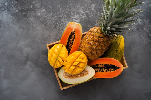 Fresh tropical fruit in a tray, top view