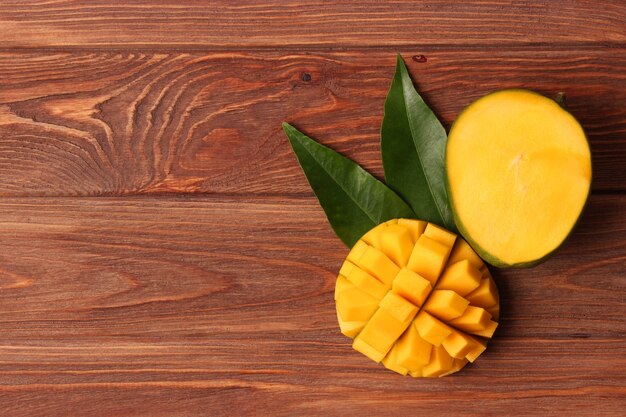 Fresh tropical mango fruit on wooden background top view