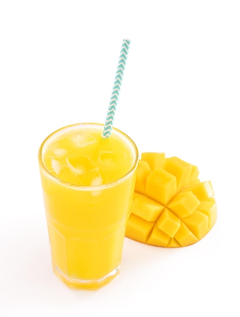 Fresh tropical mango juice with beautiful diced pulp and striped paper straw isolated on white background table close up cut out clipping path