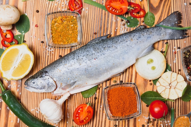 Fresh trout with spices and seasonings top view, flat lay