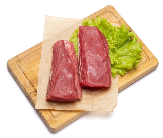 Fresh tuna fish steak on a wooden cutting serving board isolated on a white background