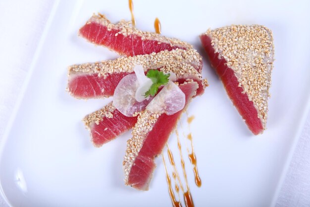 Fresh tuna meat sliced at white plate