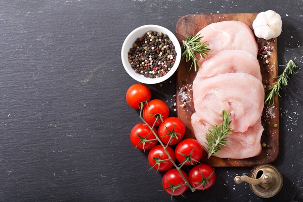 Fresh turkey meat on wooden board, top view