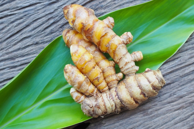 Fresh turmeric on old wooden table. herbal