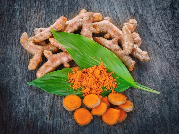 Fresh turmeric roots on wooden table