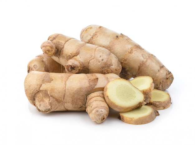 Fresh turmeric on white wall