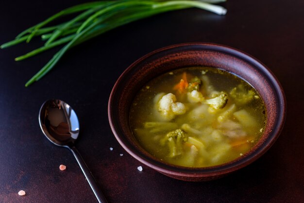 Fresh vegan soup with broccoli, cauliflower, asparagus and carrots. Useful healthy vegan food