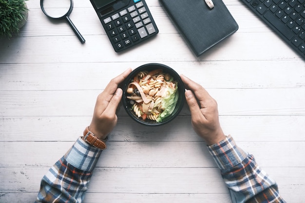 fresh vegetable salad in bowl on office desk