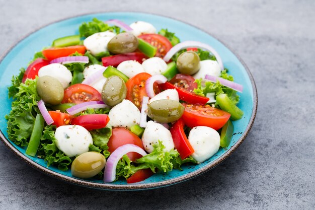 Fresh vegetable salad. Caprese. Caprese salad. Italian salad. Mediterranean salad. Italian cuisine. 
