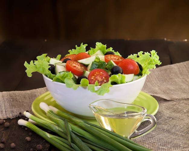 Fresh vegetable salad on dark wooden background