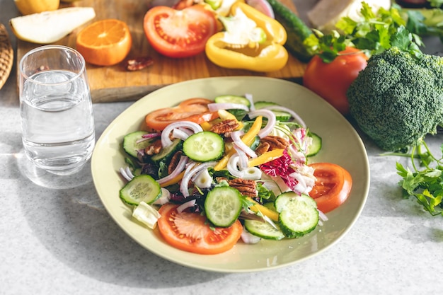 Fresh vegetable salad on the kitchen table in a plate closeup