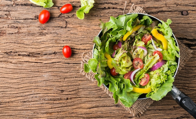 fresh vegetable salad on old wooden background