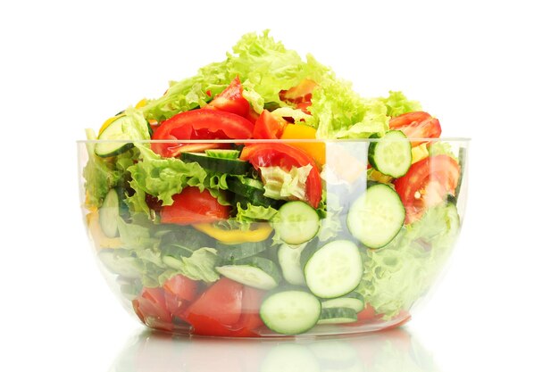 Fresh vegetable salad in transparent bowl isolated on white