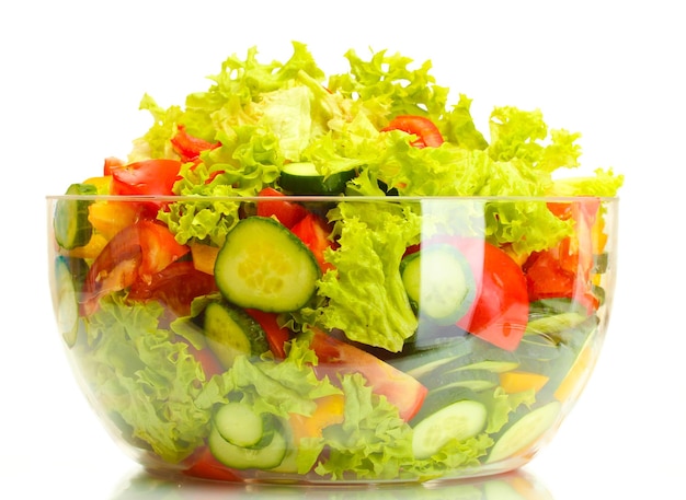 Fresh vegetable salad in transparent bowl isolated on white