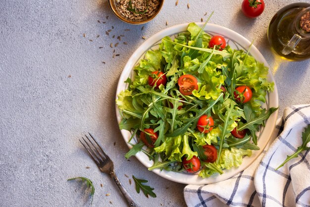 Fresh vegetable salad with tomatoes arugola lettuce and other ingredients healthy eating